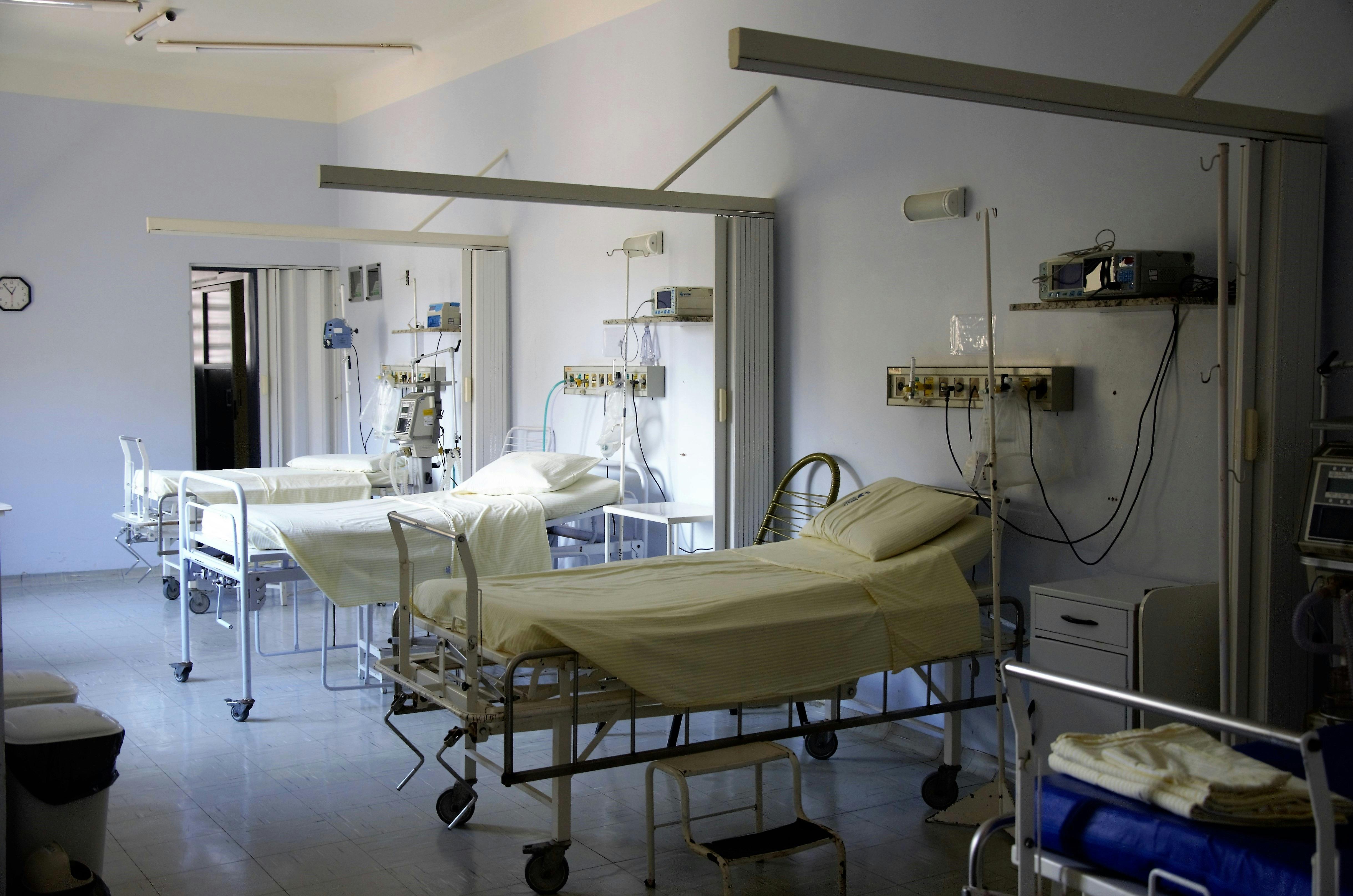 Hospital beds in an empty hospital room
